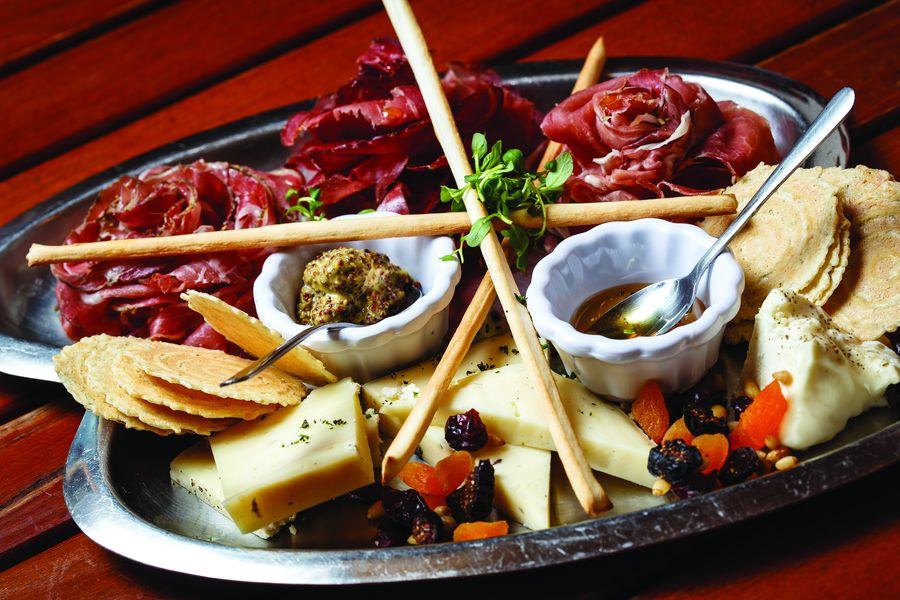 The Alpino Vino antipasto board of cured meats, Italian cheeses, breadsticks, rosemary crisps, truffle honey, stone ground mustard and dried fruit