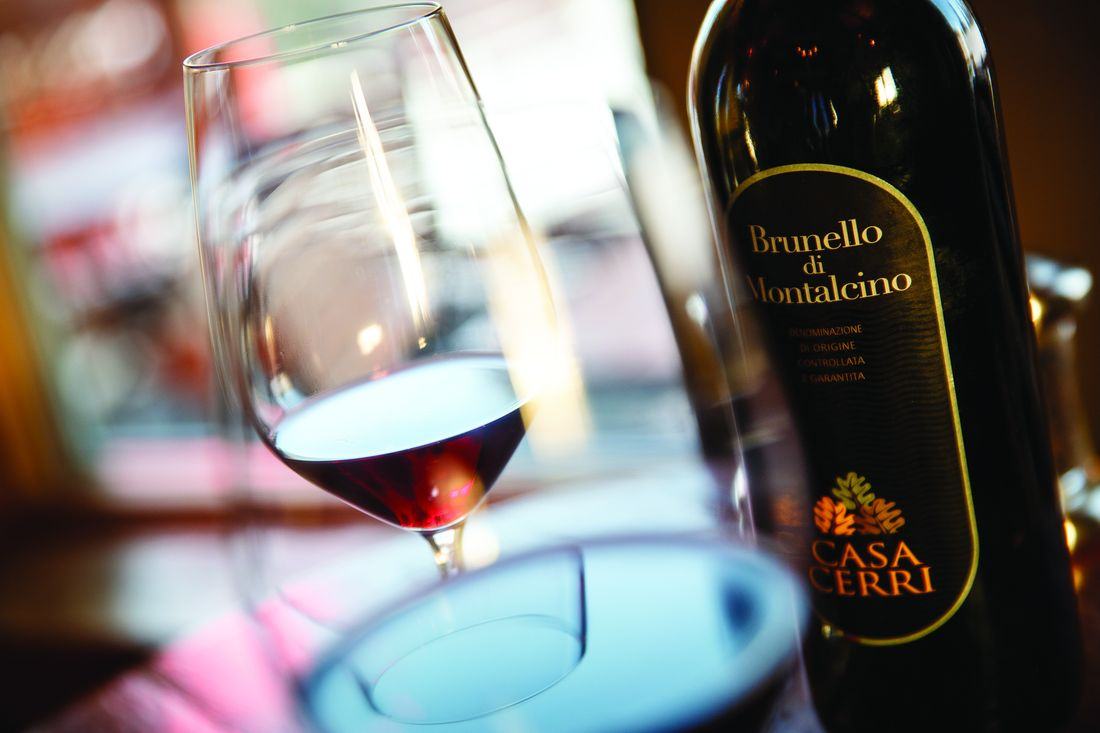A bottle of Brunello di Montalcino beside a poured glass of red wine at Alpino Vino, 11,966 feet above Telluride
