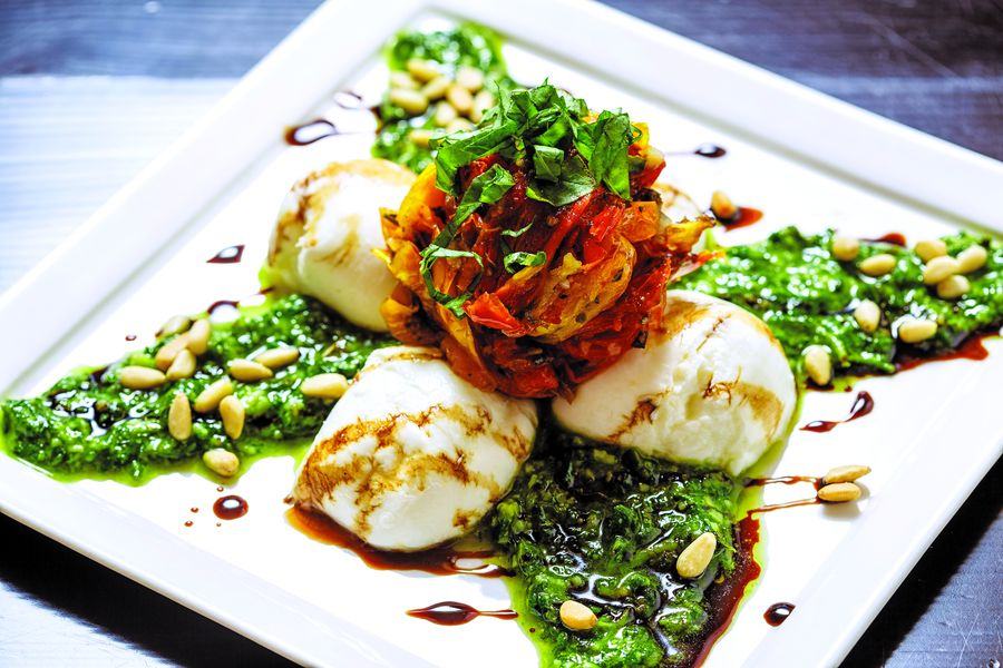 Insalata Caprese at Alpino Vino: buffalo mozzarella with house-made basil pesto, oven-roasted tomatoes and toasted pine nuts