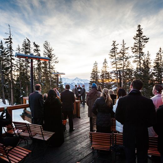 Wedding guests gathered on the Alpino Vino deck at sunset, with the San Juan peaks behind, Telluride Ski Resort