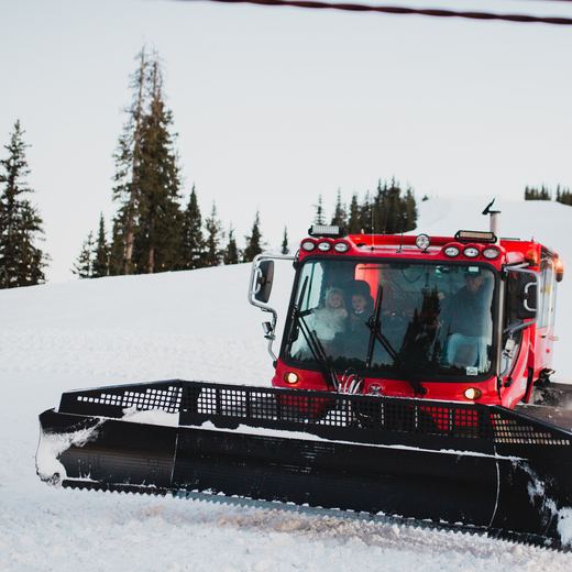 The red Alpino Vino snowcoach coming up the run with the wedding party aboard at 11,966 feet